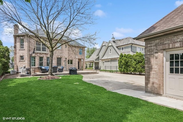 view of green lawn featuring a patio area