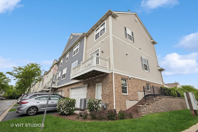 1119 Orangery Ct, Carol Stream, IL 60188 - view of side of home featuring brick siding, a garage, a balcony, and a yard