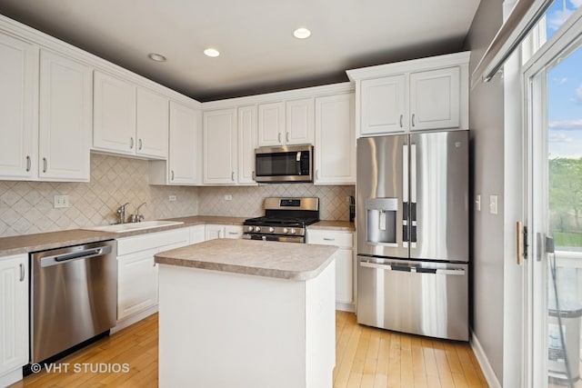 1119 Orangery Ct, Carol Stream, IL 60188 - kitchen with appliances with stainless steel finishes, white cabinets, tasteful backsplash, light wood-style flooring, and recessed lighting