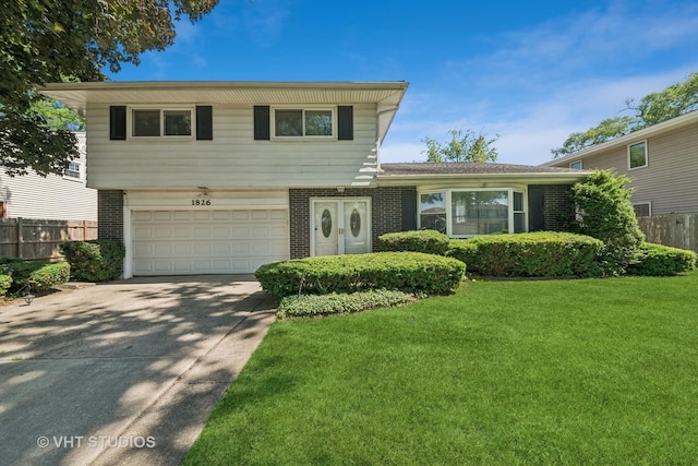 1826 E Tano Ln, Mount Prospect, IL 60056 - split level home with brick siding, an attached garage, and driveway
