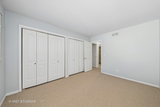1826 E Tano Ln, Mount Prospect, IL 60056 - unfurnished bedroom featuring light carpet and two closets