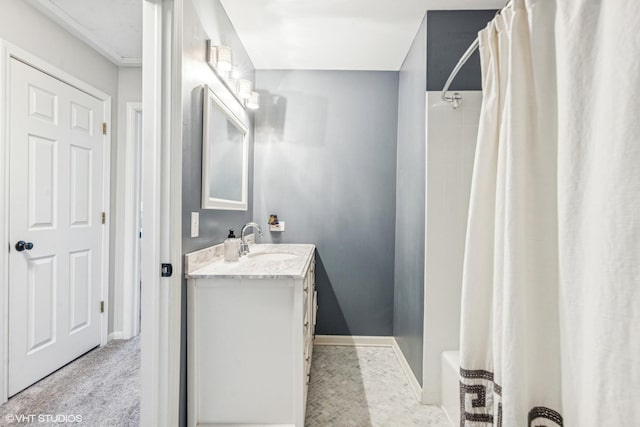 bathroom with vanity, a shower with curtain, and baseboards