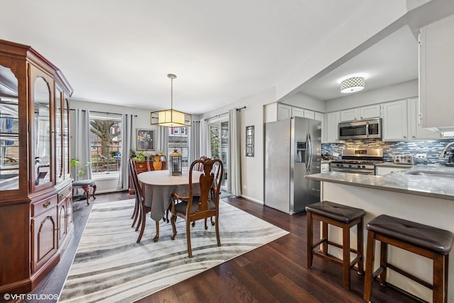dining area with dark wood finished floors
