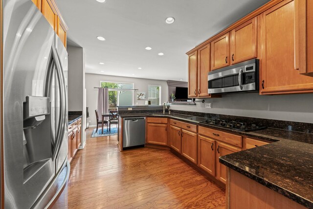 401 Manchester Rd, Oswego, IL 60543 - kitchen featuring appliances with stainless steel finishes, a peninsula, a sink, recessed lighting, and wood finished floors