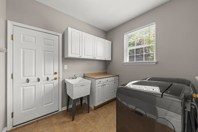 401 Manchester Rd, Oswego, IL 60543 - laundry room featuring washer and dryer, cabinet space, and light floors