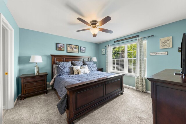 401 Manchester Rd, Oswego, IL 60543 - bedroom with baseboards, light colored carpet, and ceiling fan
