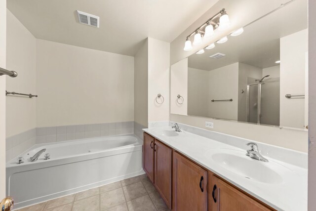 401 Manchester Rd, Oswego, IL 60543 - full bathroom featuring a garden tub, double vanity, tile patterned floors, and a shower with door