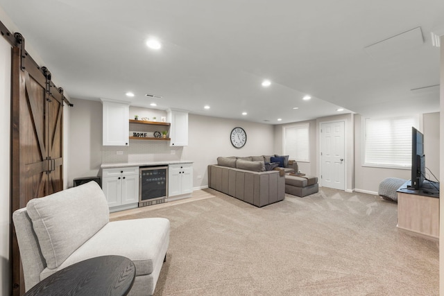 401 Manchester Rd, Oswego, IL 60543 - living room featuring beverage cooler, a barn door, a bar, baseboards, and recessed lighting