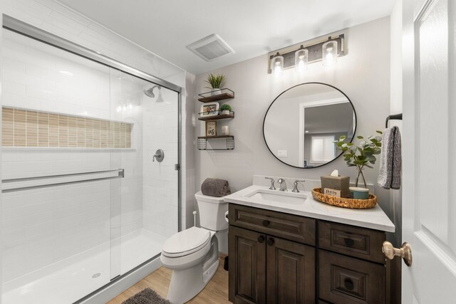 401 Manchester Rd, Oswego, IL 60543 - bathroom with toilet, vanity, a stall shower, and wood finished floors