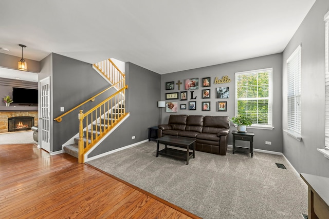 401 Manchester Rd, Oswego, IL 60543 - living area featuring stairway, baseboards, a fireplace, and wood finished floors
