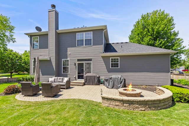 401 Manchester Rd, Oswego, IL 60543 - back of property featuring a patio, a chimney, and an outdoor living space with a fire pit