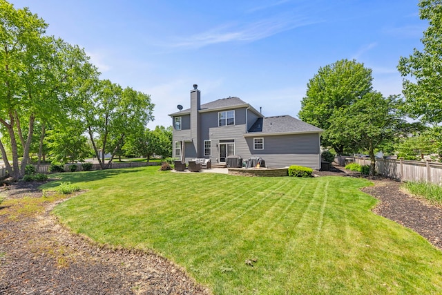 401 Manchester Rd, Oswego, IL 60543 - rear view of house with a chimney, a patio, and an outdoor living space