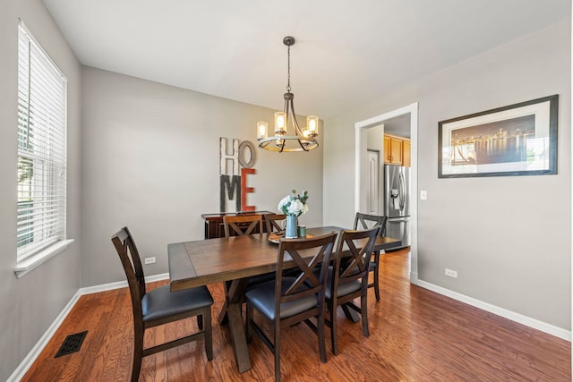 401 Manchester Rd, Oswego, IL 60543 - dining space featuring a chandelier, wood finished floors, and baseboards
