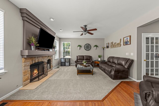 401 Manchester Rd, Oswego, IL 60543 - living room with a ceiling fan, a fireplace, wood finished floors, and baseboards