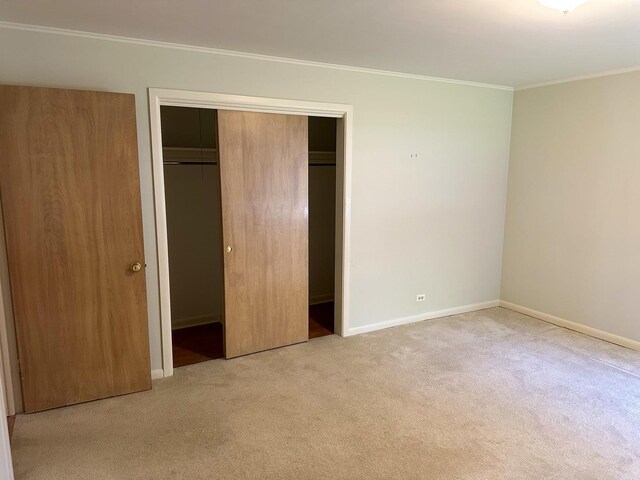 6600 N Kenton Ave, Lincolnwood, IL 60712 - unfurnished bedroom featuring carpet, crown molding, a closet, and baseboards