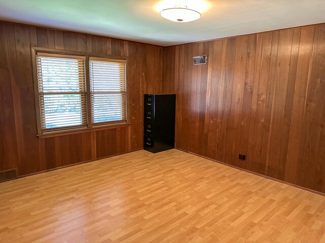 6600 N Kenton Ave, Lincolnwood, IL 60712 - spare room featuring wood finished floors and wood walls