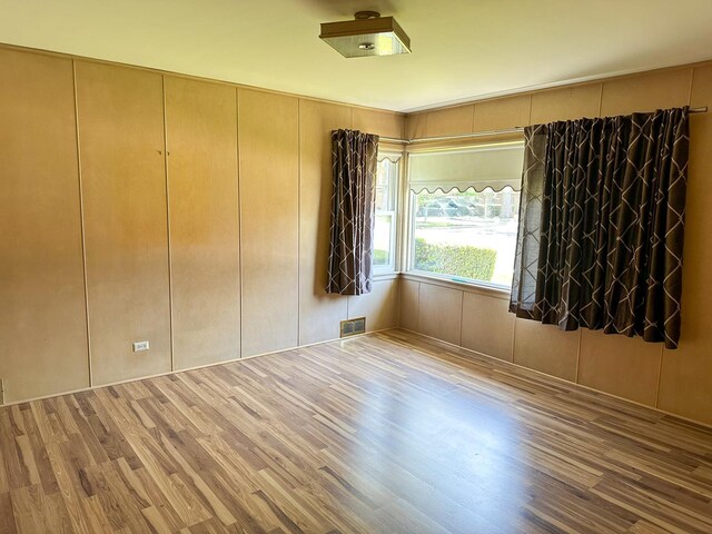6600 N Kenton Ave, Lincolnwood, IL 60712 - unfurnished room with wood finished floors