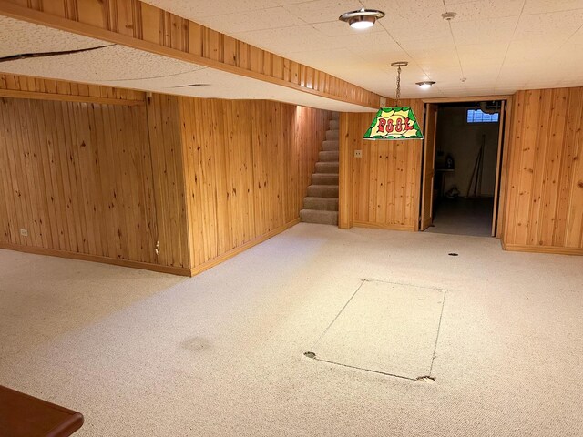 6600 N Kenton Ave, Lincolnwood, IL 60712 - finished below grade area with stairway, wooden walls, carpet floors, and baseboards