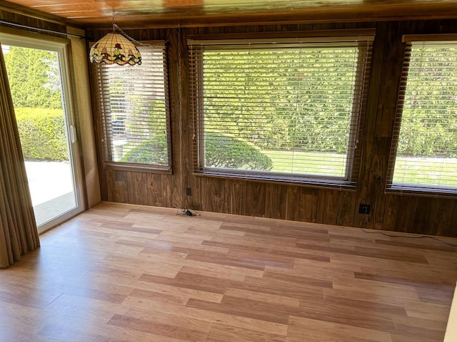 6600 N Kenton Ave, Lincolnwood, IL 60712 - unfurnished dining area featuring wooden walls and light wood-style floors