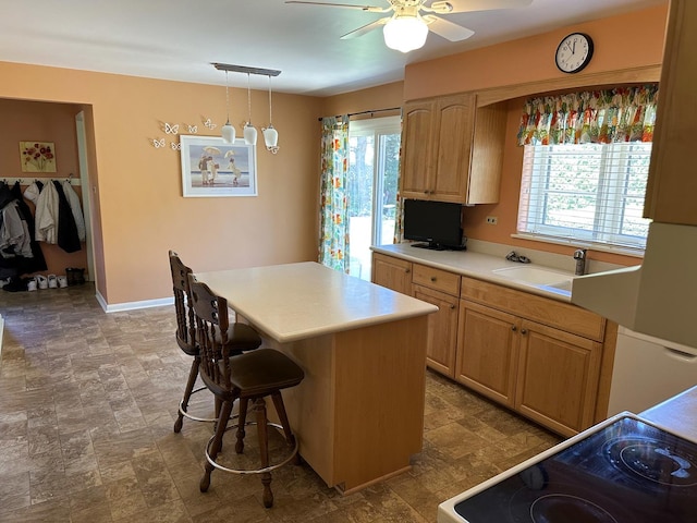 6600 N Kenton Ave, Lincolnwood, IL 60712 - kitchen featuring electric stove, a sink, a kitchen island, light countertops, and ceiling fan