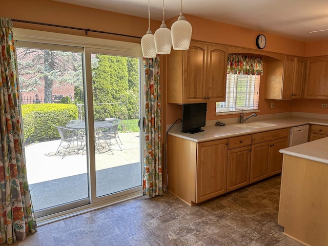 6600 N Kenton Ave, Lincolnwood, IL 60712 - kitchen featuring a sink, light countertops, stone finish floors, and white dishwasher