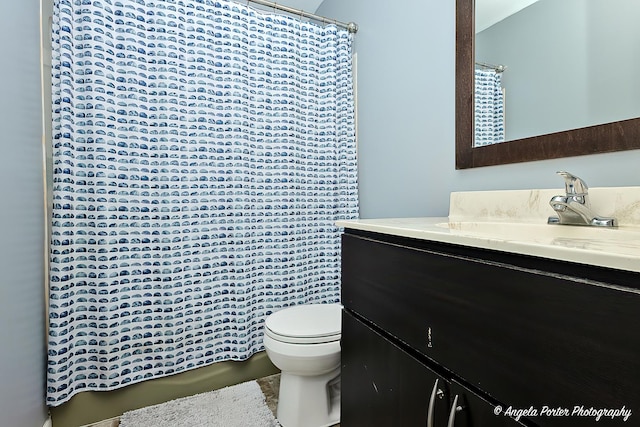 716 Lagoon Ter, Round Lake Beach, IL 60073 - bathroom with toilet, vanity, and a shower with shower curtain