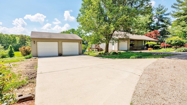 view of front of home featuring an outdoor structure and a detached garage