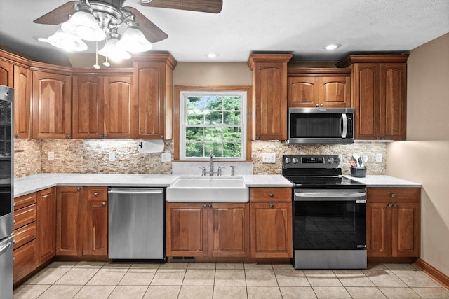 19423 Lakeside Ln, Bloomington, IL 61705 - kitchen featuring appliances with stainless steel finishes, a sink, ceiling fan, and light countertops