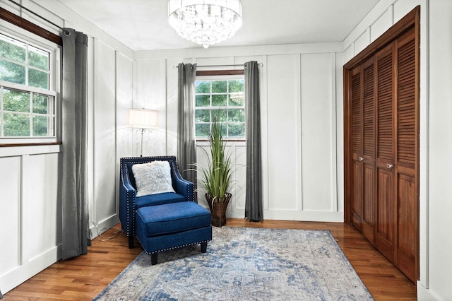 19423 Lakeside Ln, Bloomington, IL 61705 - sitting room with a chandelier, wood finished floors, and a decorative wall