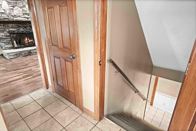 19423 Lakeside Ln, Bloomington, IL 61705 - stairs featuring tile patterned floors, a fireplace, and baseboards