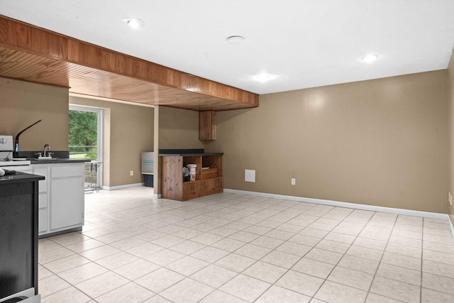 19423 Lakeside Ln, Bloomington, IL 61705 - kitchen with dark countertops, baseboards, light tile patterned floors, recessed lighting, and white cabinets