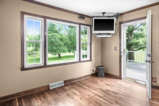 19423 Lakeside Ln, Bloomington, IL 61705 - unfurnished dining area with crown molding, baseboards, and light wood-type flooring
