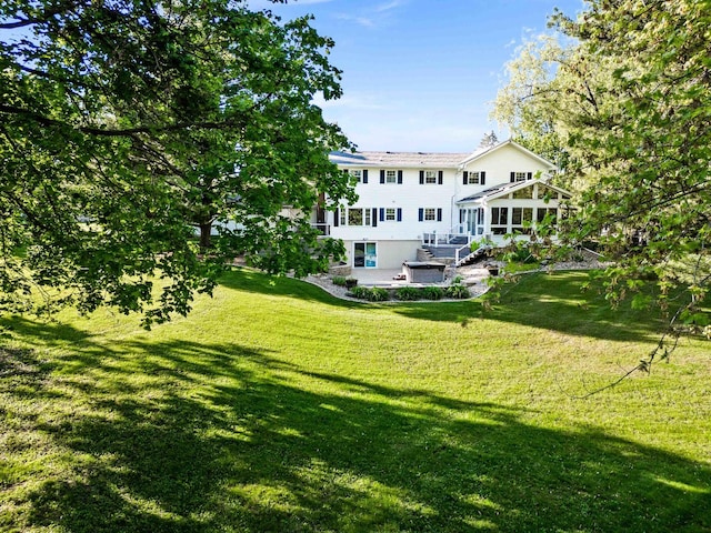 19423 Lakeside Ln, Bloomington, IL 61705 - rear view of house with a lawn and a sunroom