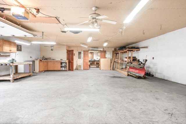 19423 Lakeside Ln, Bloomington, IL 61705 - garage featuring a workshop area, ceiling fan, and a garage door opener
