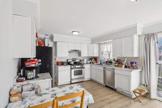 35634 N Greenleaf Ave, Ingleside, IL 60041 - kitchen with appliances with stainless steel finishes, crown molding, decorative backsplash, and light countertops