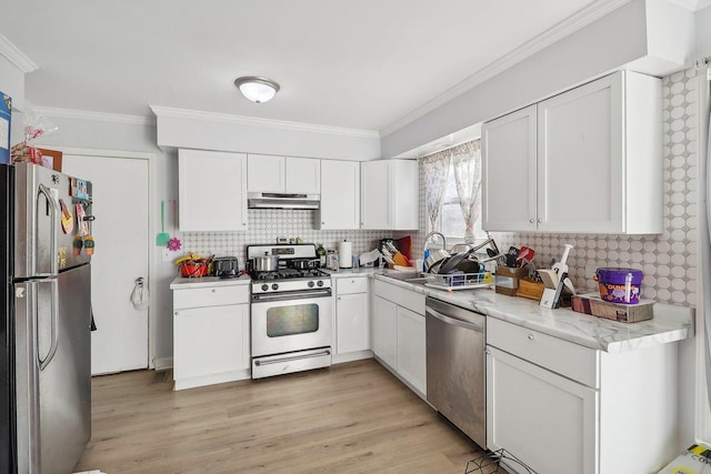 35634 N Greenleaf Ave, Ingleside, IL 60041 - kitchen with appliances with stainless steel finishes, ornamental molding, tasteful backsplash, white cabinets, and under cabinet range hood