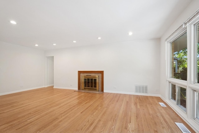 9032 Crawford Ave, Skokie, IL 60076 - unfurnished living room with light wood-type flooring, recessed lighting, baseboards, and a glass covered fireplace