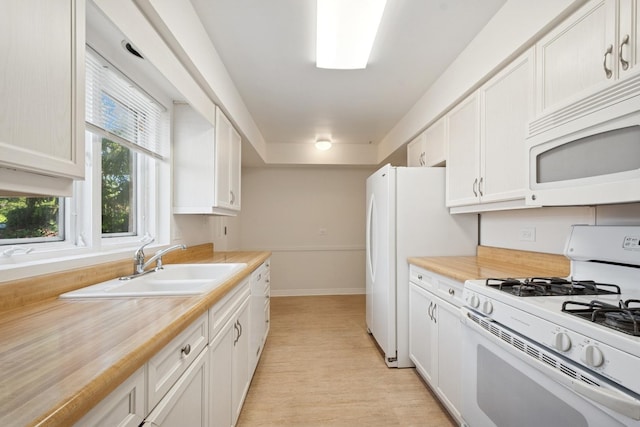 9032 Crawford Ave, Skokie, IL 60076 - kitchen with white appliances, a sink, baseboards, white cabinetry, and light wood-type flooring