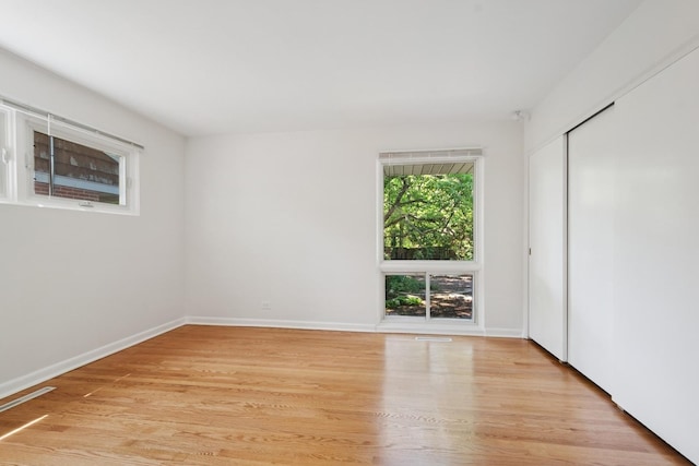 9032 Crawford Ave, Skokie, IL 60076 - unfurnished bedroom featuring light wood finished floors, baseboards, and a closet