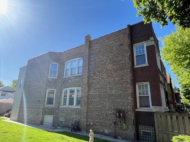 3415 S Emerald Ave, Chicago, IL 60616 - view of property exterior with brick siding and a chimney