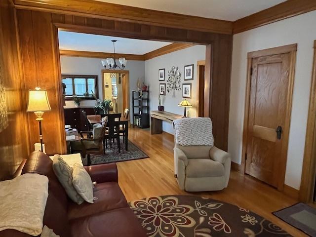3415 S Emerald Ave, Chicago, IL 60616 - living room featuring a chandelier, wood finished floors, and crown molding