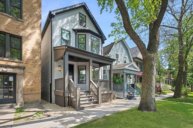 1542 W Highland Ave, Chicago, IL 60660 - view of front of home featuring a porch and a front yard
