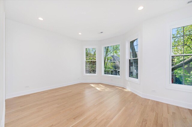 1542 W Highland Ave, Chicago, IL 60660 - empty room with plenty of natural light, light wood finished floors, baseboards, and recessed lighting