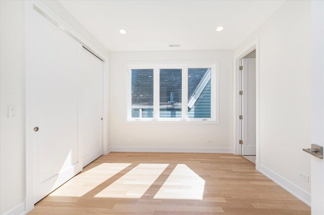 1542 W Highland Ave, Chicago, IL 60660 - unfurnished bedroom featuring light wood-type flooring, baseboards, recessed lighting, and a closet