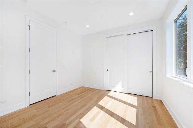 1542 W Highland Ave, Chicago, IL 60660 - unfurnished bedroom featuring light wood-style flooring, baseboards, a closet, and recessed lighting