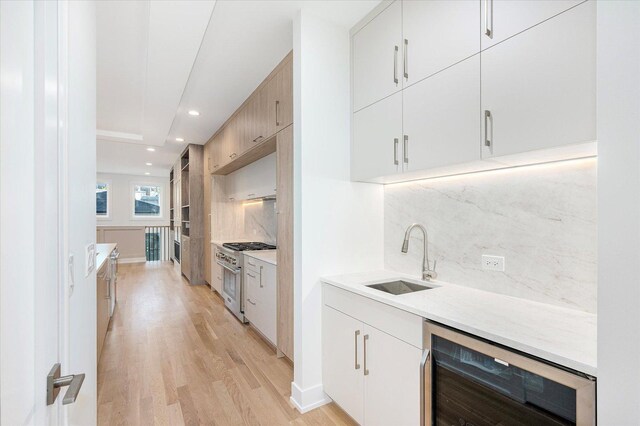 1542 W Highland Ave, Chicago, IL 60660 - bar with wine cooler, a sink, stainless steel stove, tasteful backsplash, and light wood-style flooring