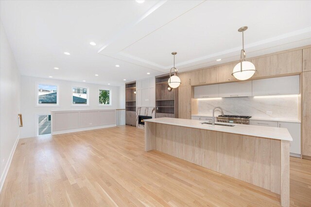 1542 W Highland Ave, Chicago, IL 60660 - kitchen with modern cabinets, light brown cabinets, a sink, light countertops, and light wood finished floors