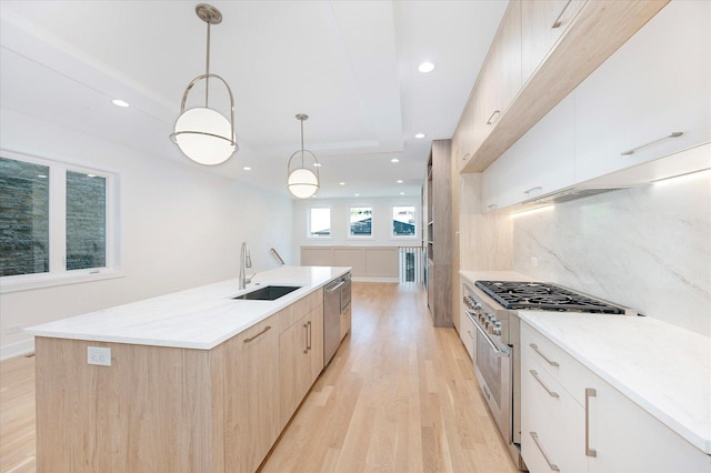 1542 W Highland Ave, Chicago, IL 60660 - kitchen featuring appliances with stainless steel finishes, light wood-style flooring, a sink, modern cabinets, and recessed lighting