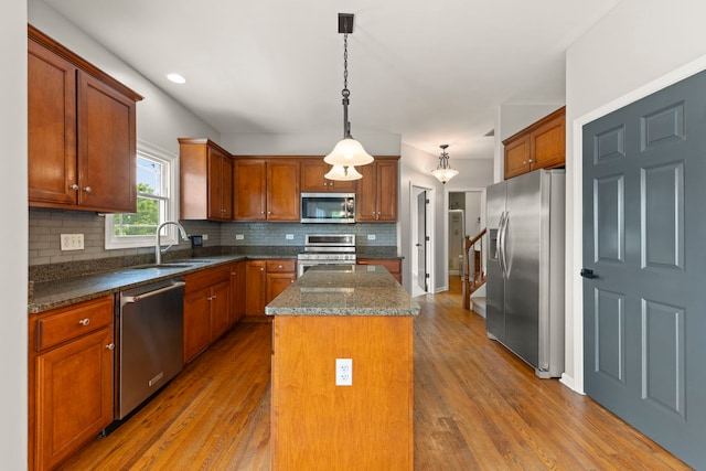 24006 Skyler Ln, Plainfield, IL 60586 - kitchen featuring stainless steel appliances, a center island, tasteful backsplash, and wood finished floors