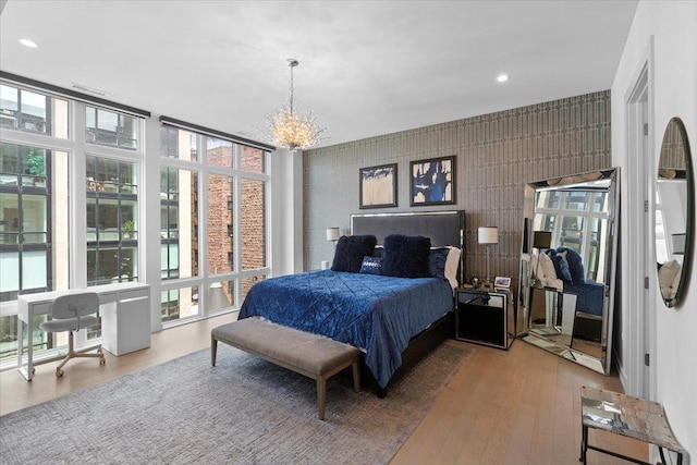 2773 N Hampden Ct Unit Ph03, Chicago, IL 60614 - bedroom featuring a chandelier, wood finished floors, multiple windows, floor to ceiling windows, and recessed lighting
